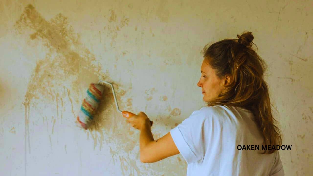 Person painting a vintage dresser for rustic farmhouse decor on a budget using light grey chalk paint.