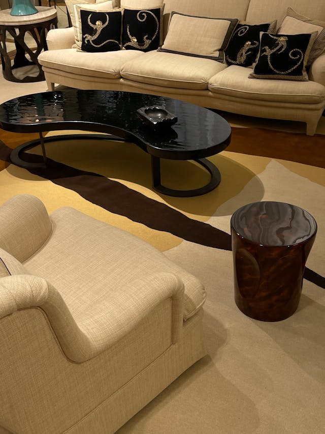 Interior view of a modern home showing a curved arched doorway and a rounded organic-shaped coffee table